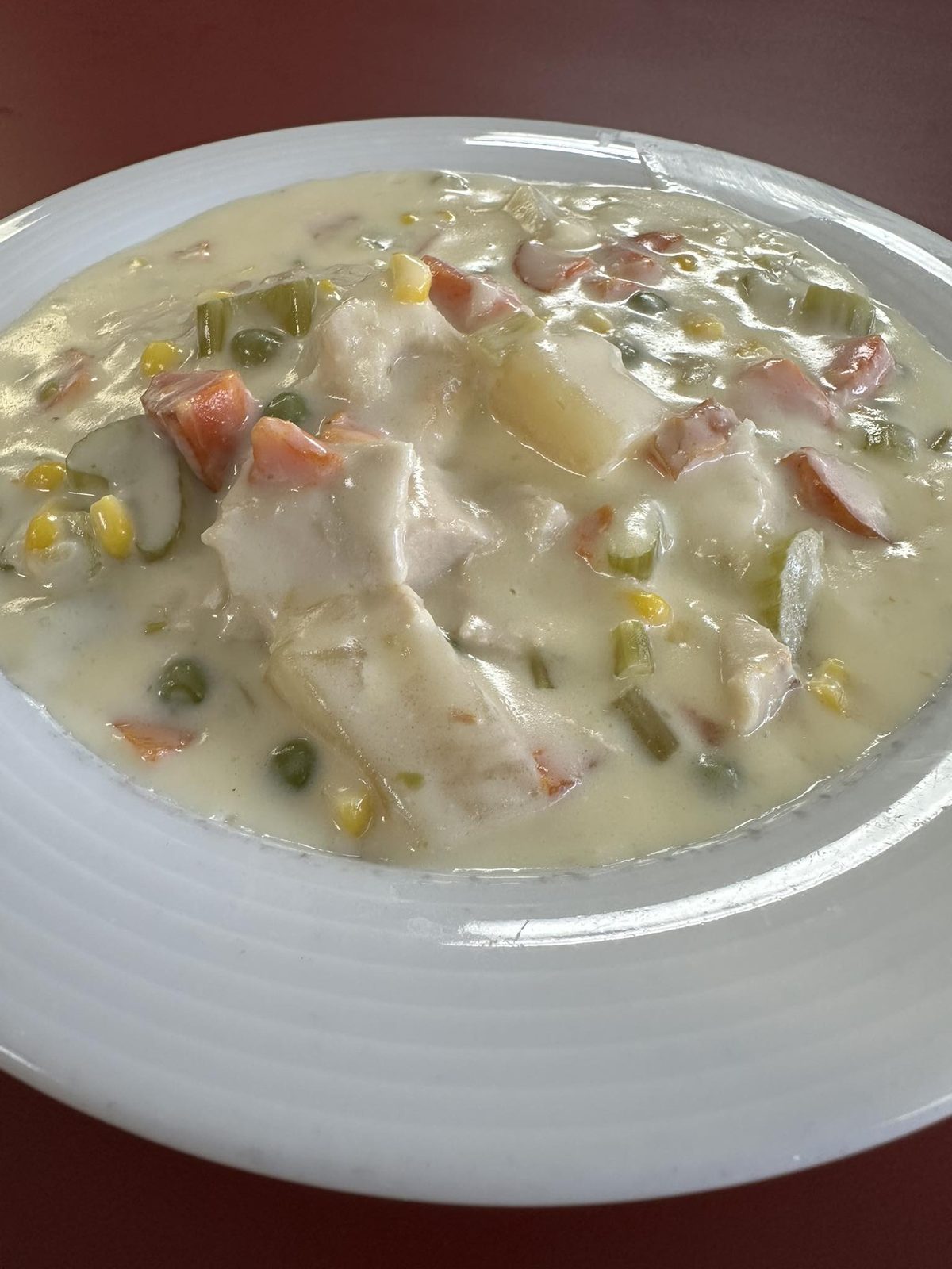 Creamed chicken and vegetables over biscuits