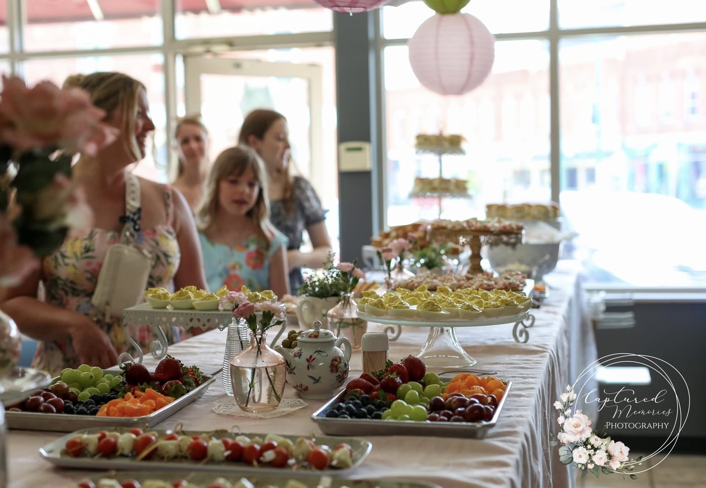 Shower buffet spread with fruit, deviled eggs, and sandwiches