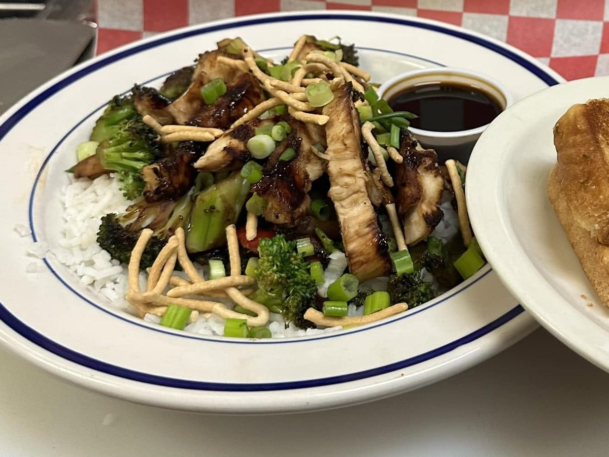 Pork stir fry over rice with broccoli, crispy noodles and toast