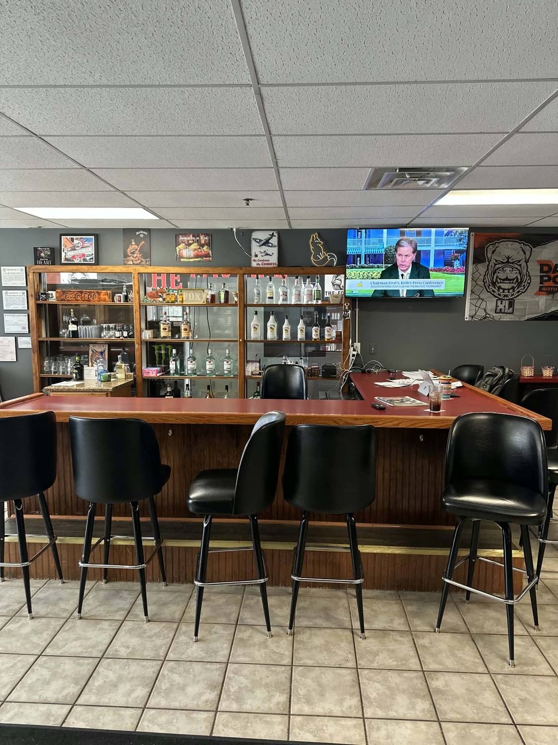 The Fox Den bar with liquor shelves and TV