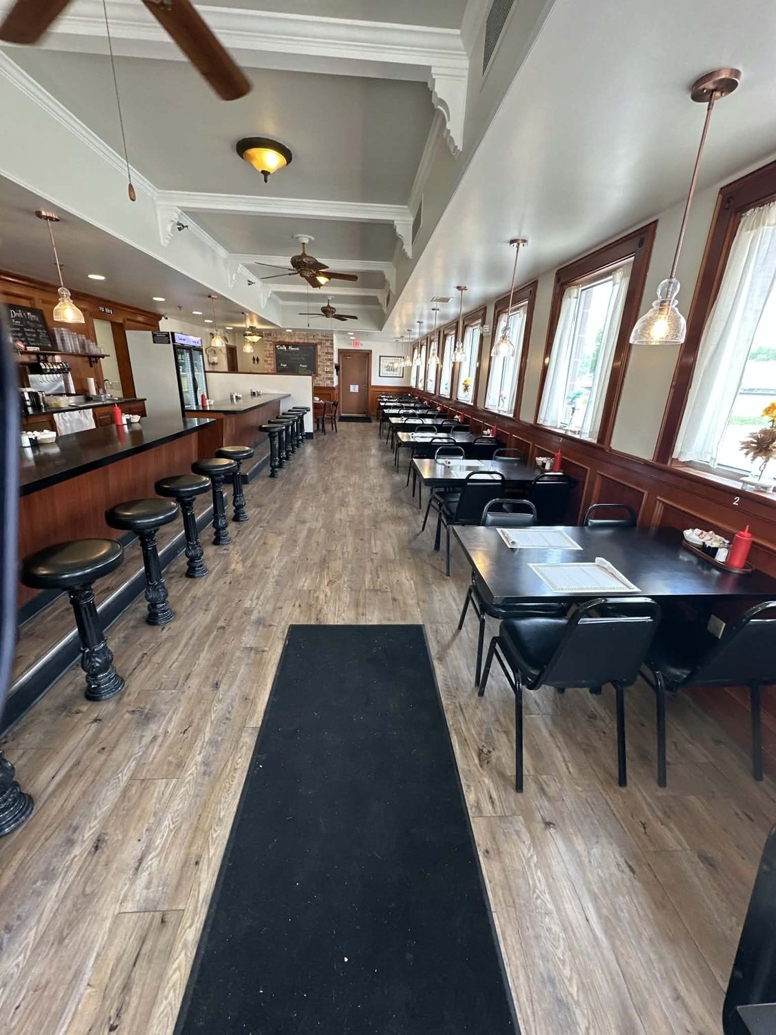 Diner counter and sunny window tables at The Fox Den