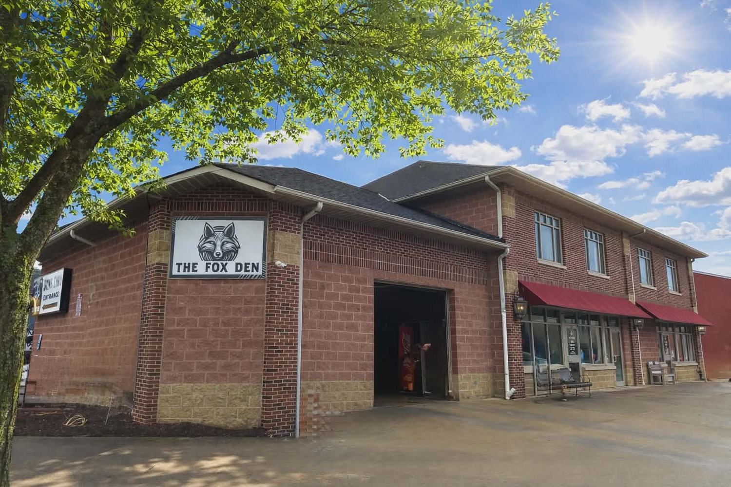 The Fox Den brick building on a sunny day in Wellington, Ohio