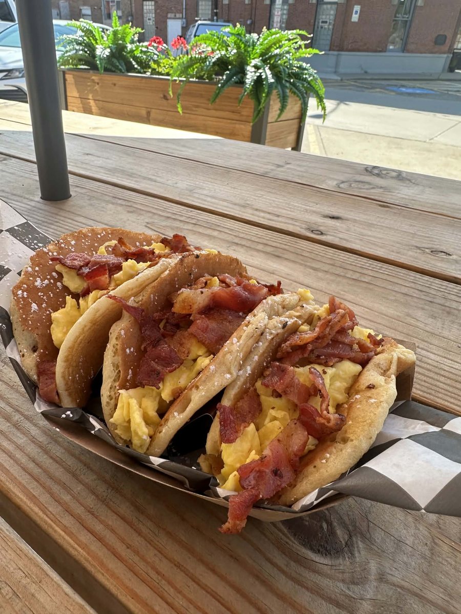 Pancake tacos filled with scrambled egg and bacon in a basket